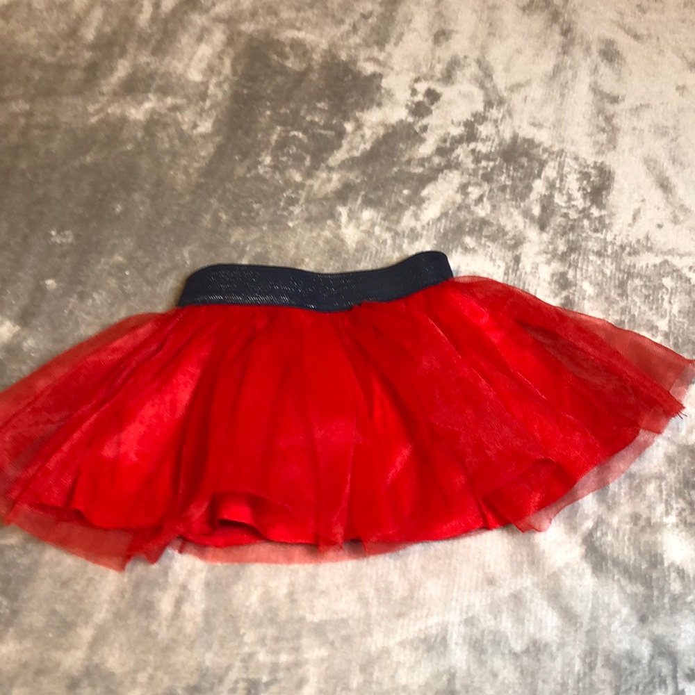 New. Wore once. 0-3 months Fuffly skirt. Red with Navy stretchy waistband.